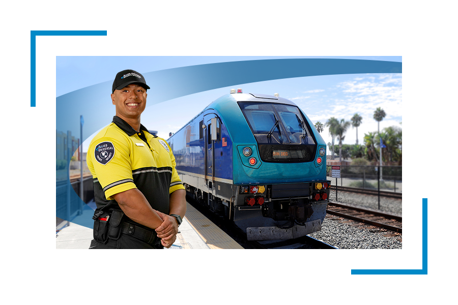 A uniformed security guard standing in a eait station with a train in the background